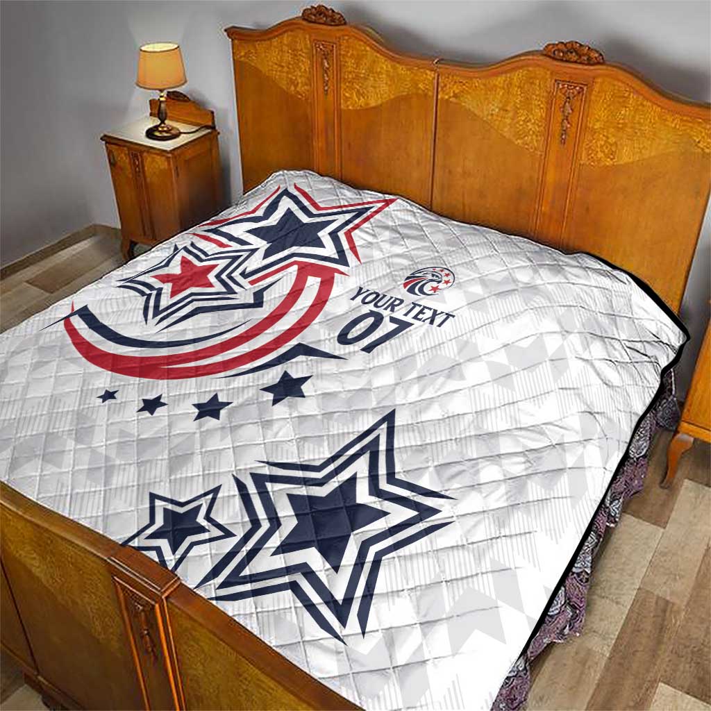White quilt covering a bed with blue and red star and patriotic emblem print