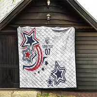 White quilt hanging on wooden exterior with blue and red star graphics