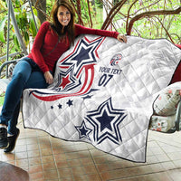 White custom quilt draped over couch with blue stars and red patriotic swirl