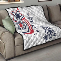 White quilt over gray sofa showing large blue and red star emblem and stars