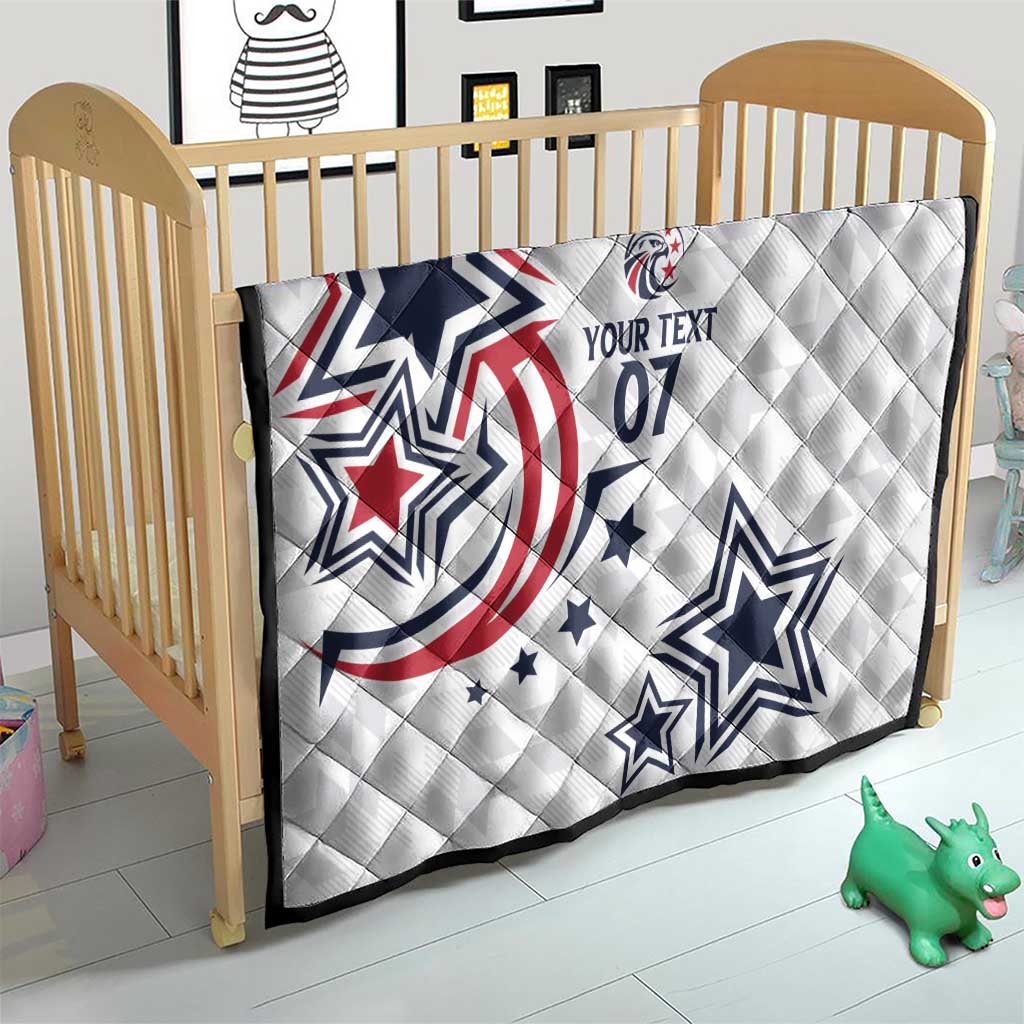 White custom quilt on a toddler bed with blue stars and red patriotic print