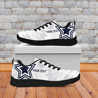 Pair of white low-top sneakers with black sole, blue star and custom text detail