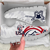 White low-top sneakers with black sole, USA logo and red-white stripes graphic