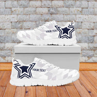 White low-top sneakers on a box, black sole with blue star and USA graphics