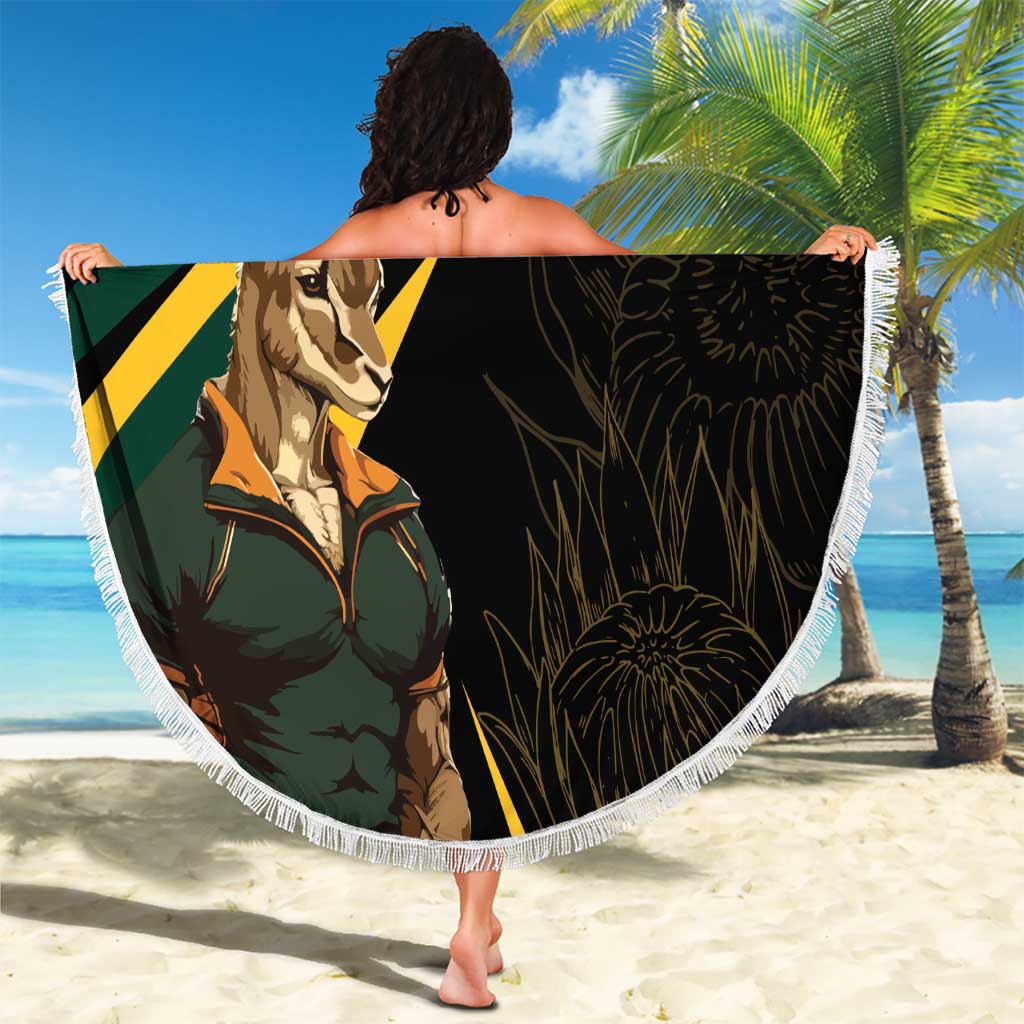Person holding a round beach blanket with springbok mascot and yellow-green diagonal stripes