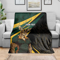 Personalized springbok mascot blanket draped on sofa with “YOUR TEXT” and diagonal stripes
