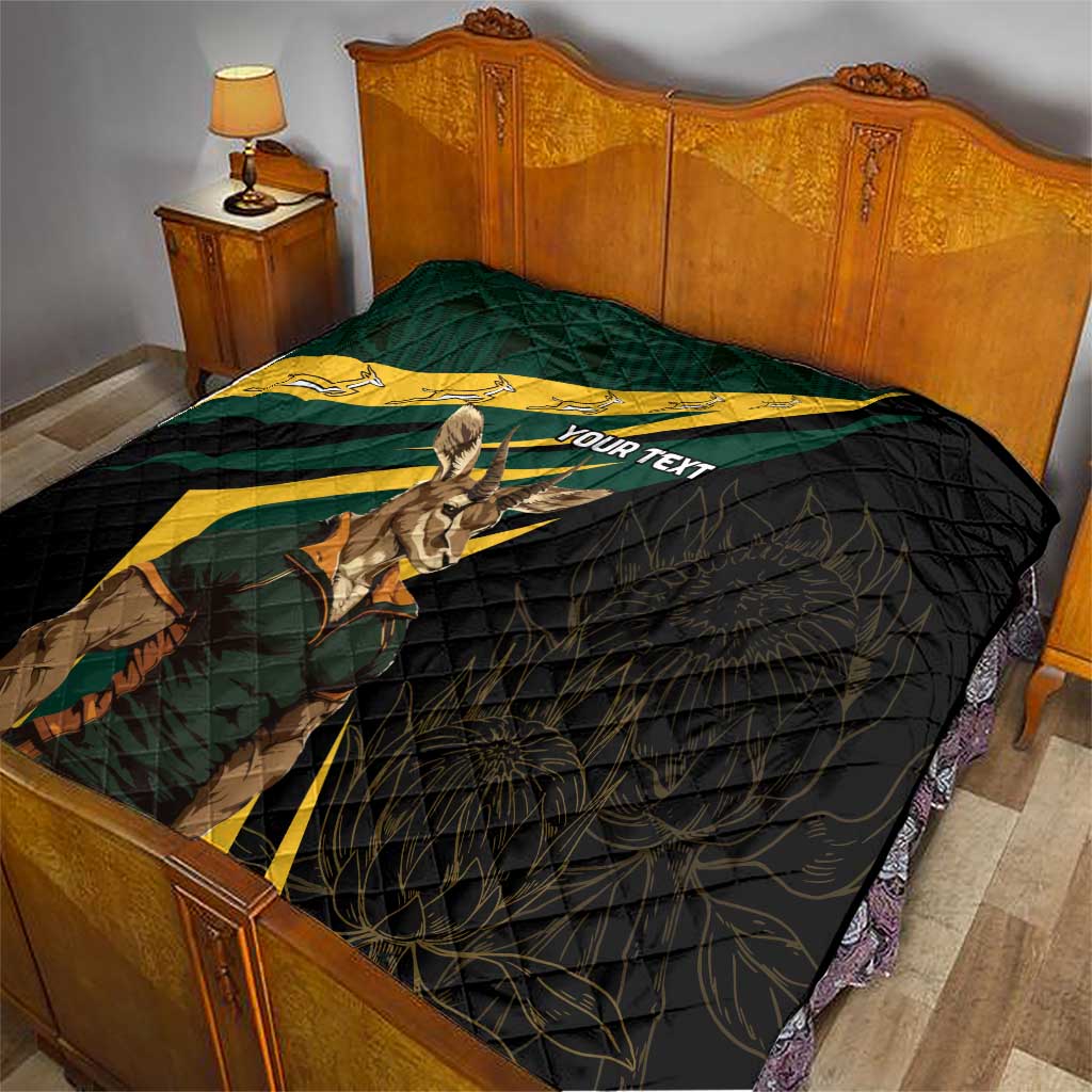Personalised quilt on bed, black quilt with South Africa flag print, springbok graphic, custom text