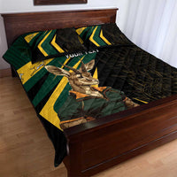 Black quilt bed set laid on bed, springbok graphic with green and yellow stripe design