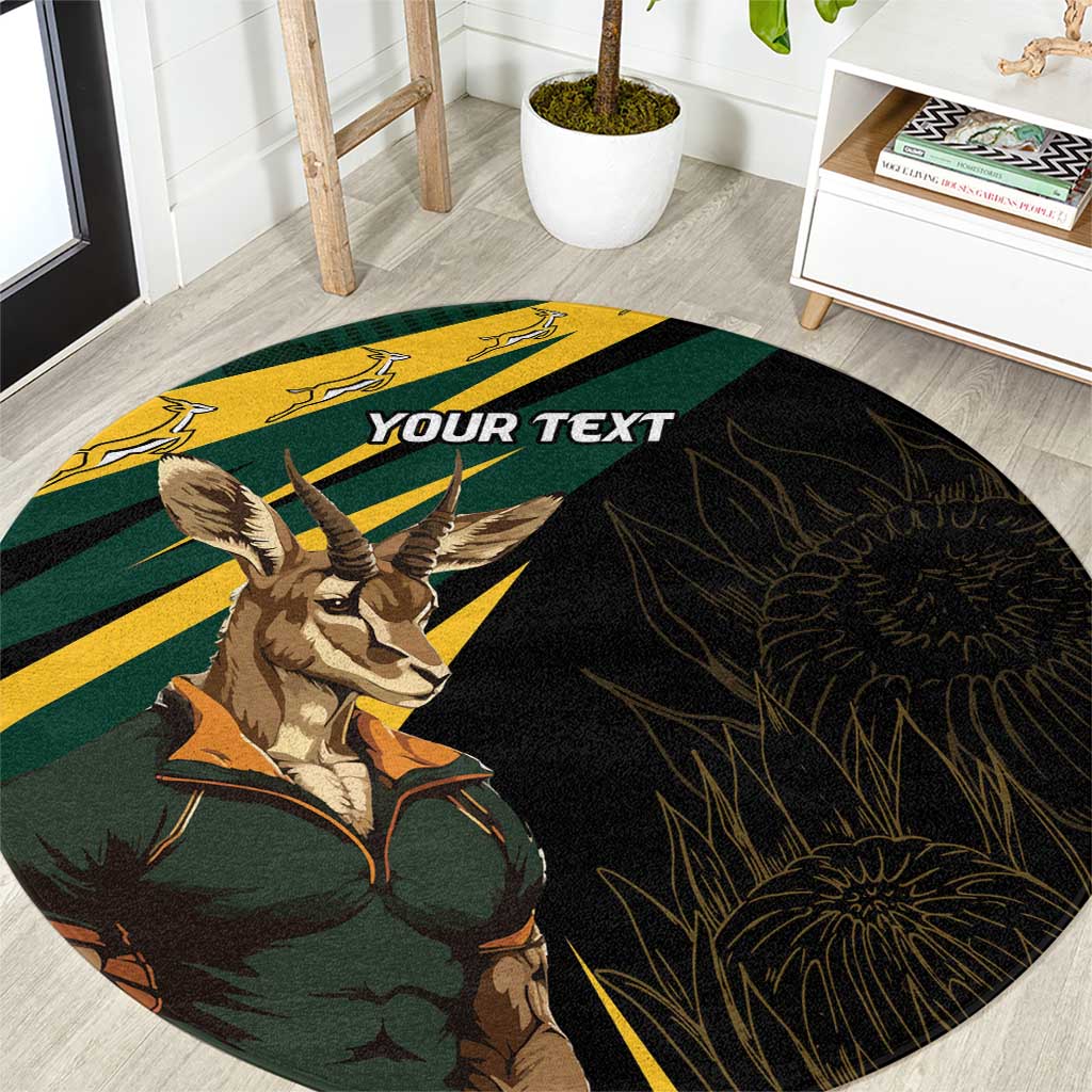 Round carpet with springbok mascot, green-and-yellow stripes on dark background