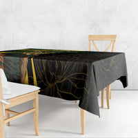 Black tablecloth corner drape with gold and green stripe and leaf design