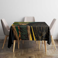 Black tablecloth on dining table with gold-striped section and leaf artwork