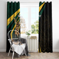 Window curtains with top grommet-style hanging, green-and-yellow striped springbok panel and dark patterned panel.