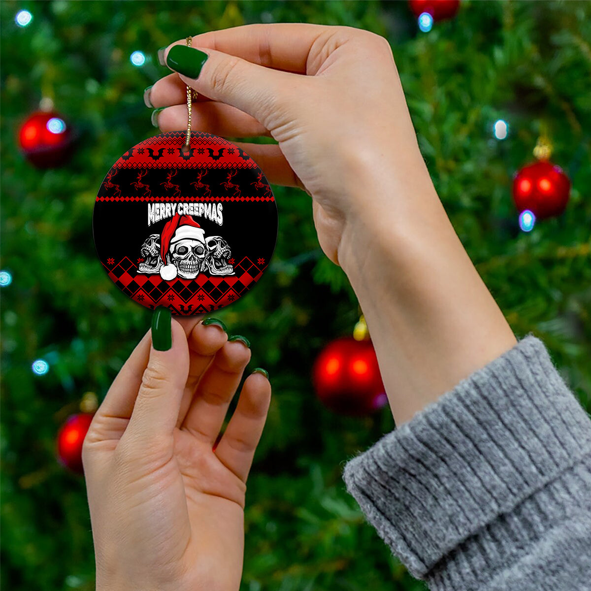 Personalized Wonder Print Christmas ceramic ornament, round black/red skull "Merry Creepmas" held