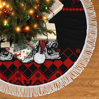 Tree skirt close-up with white fringe, red-and-black skull and diamond pattern