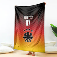 Football blanket hanging, red-to-yellow gradient with eagle emblem, stars, and 'YOUR TEXT 07'