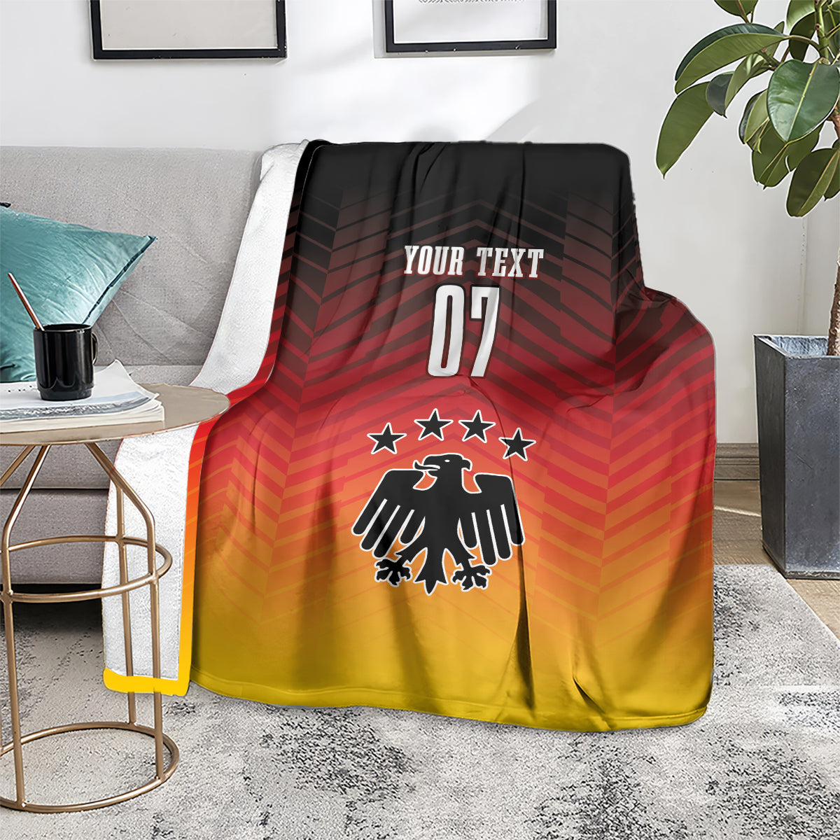Football blanket on floor chair, red-to-yellow gradient with eagle emblem, stars, 'YOUR TEXT 07'