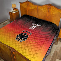Quilt blanket on bed in black, red, and yellow with German eagle, stars, and “YOUR TEXT”