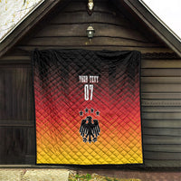 Black, red, and yellow Germany football quilt hanging indoors; eagle, stars, and “YOUR TEXT”