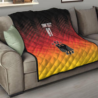 Football quilt blanket draped on sofa; black, red, and yellow with eagle emblem and “YOUR TEXT”