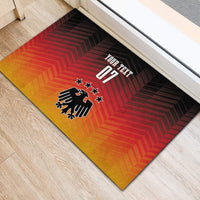 Football doormat showing “YOUR TEXT 07” above eagle crest on red and orange chevron stripes