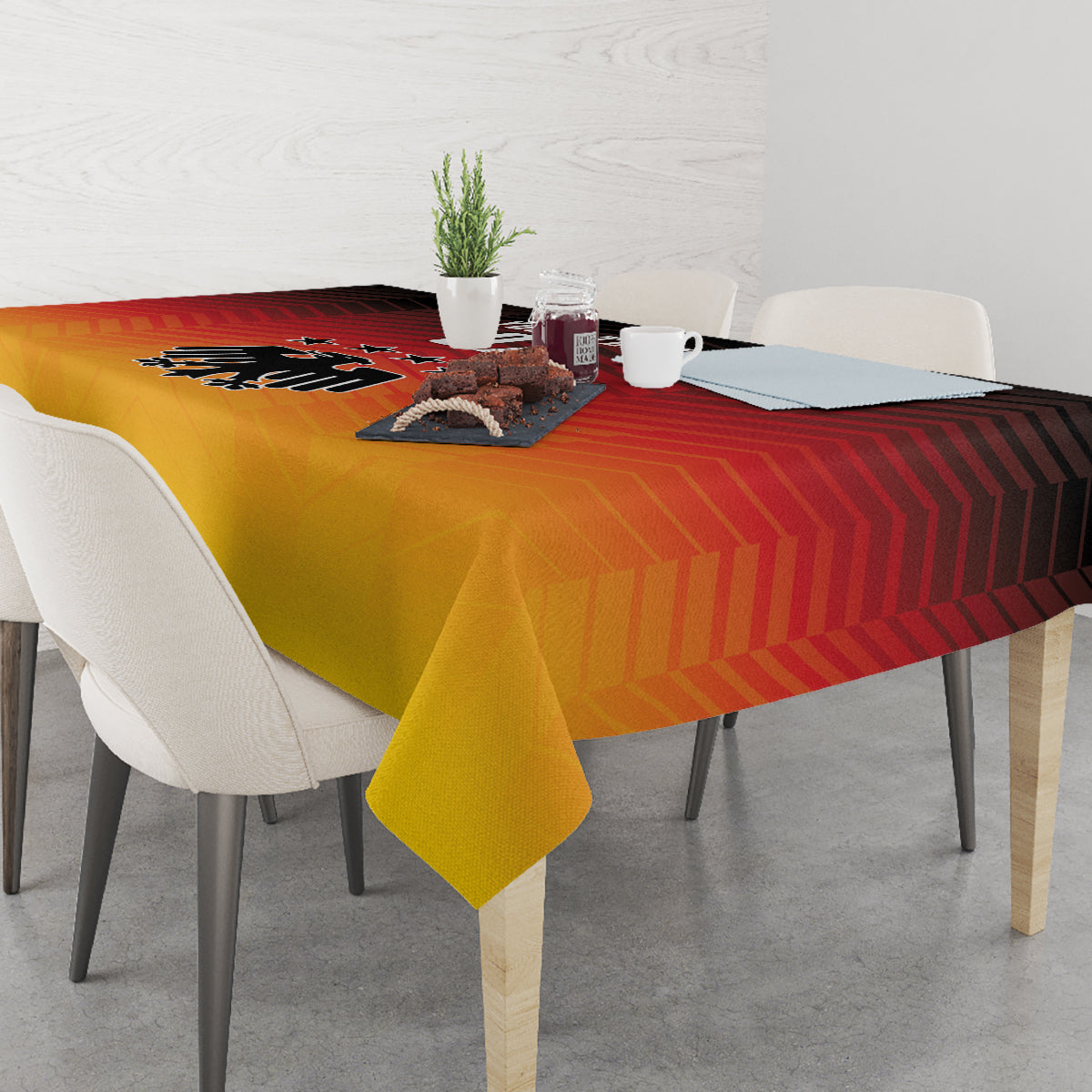 Rectangular gold yellow tablecloth with red stripes and black Germany emblem over table