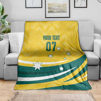 Yellow and green Olympic-themed throw blanket on sofa with “YOUR TEXT 07” and stars
