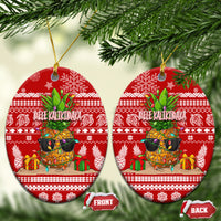 Red ceramic oval Christmas ornaments with pineapple scene and “Mele Kalikimaka” on gold strings