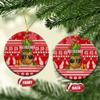 Red ceramic round Christmas ornament with pineapple and winter pattern, hanging on gold string