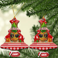 Red ceramic bell-shaped Christmas ornament pair with pineapple artwork, hanging from gold hooks