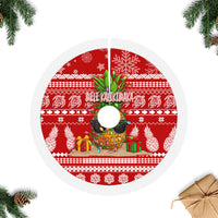 Red circular tree skirt with white fringe edge, pineapple centerpiece and holiday pattern