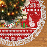 Red tree skirt with white fringe trim, pineapple and pinecone holiday scene print