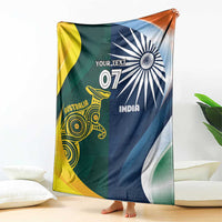 Cricket blanket draped, half Australia yellow-green and half India navy with 'YOUR TEXT'.