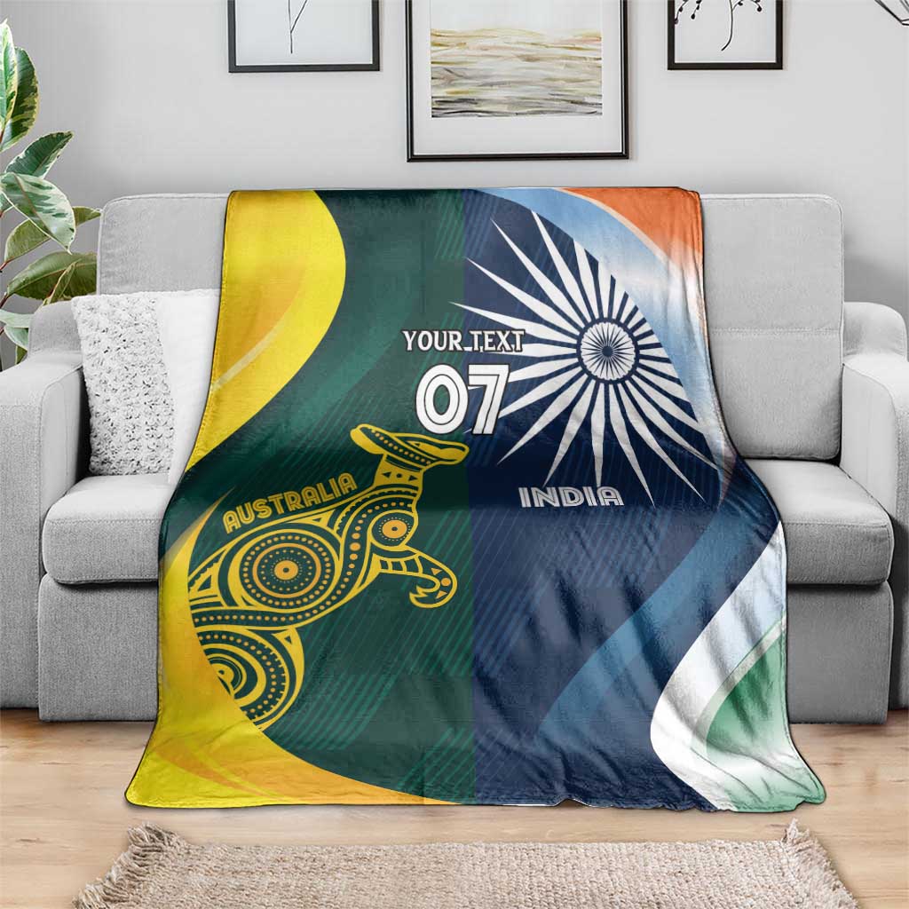 Cricket blanket on sofa, half Australia yellow-green and half India navy with 'YOUR TEXT'.