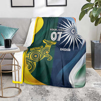 Cricket blanket over chair arm, half Australia gold-green and half India navy with 'YOUR TEXT'.