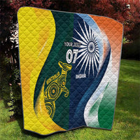 Half-and-half cricket quilt on grass, yellow side and green/blue side with emblems