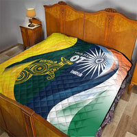 Cricket quilt on bed, yellow left half and green/blue right half with Australia and India