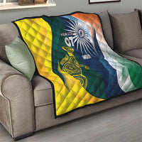 Cricket quilt on a sofa, yellow and green/blue halves with Australia and India emblems
