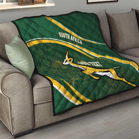 Dark green quilt on sofa with South Africa stripe design, Bokke emblem, and custom text