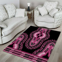 Black dashiki area rug with pink ribbon center motif and decorative edge trim.