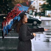 Black umbrella with Antigua & Barbuda crest and red/blue splash wing design