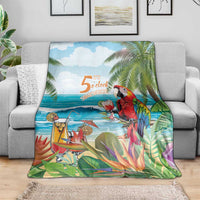 Tropical throw blanket spread out, with red parrot, tropical plants, and beach scene print