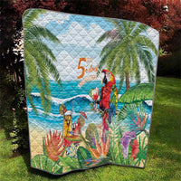 Colorful tropical quilt on grass with parrot and '5 o'clock' over ocean waves and palms