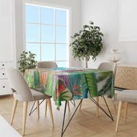Colorful tropical tablecloth draped over a dining table with palm and leaf print