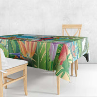Colorful tropical tablecloth with palm leaves and a parrot motif on the table
