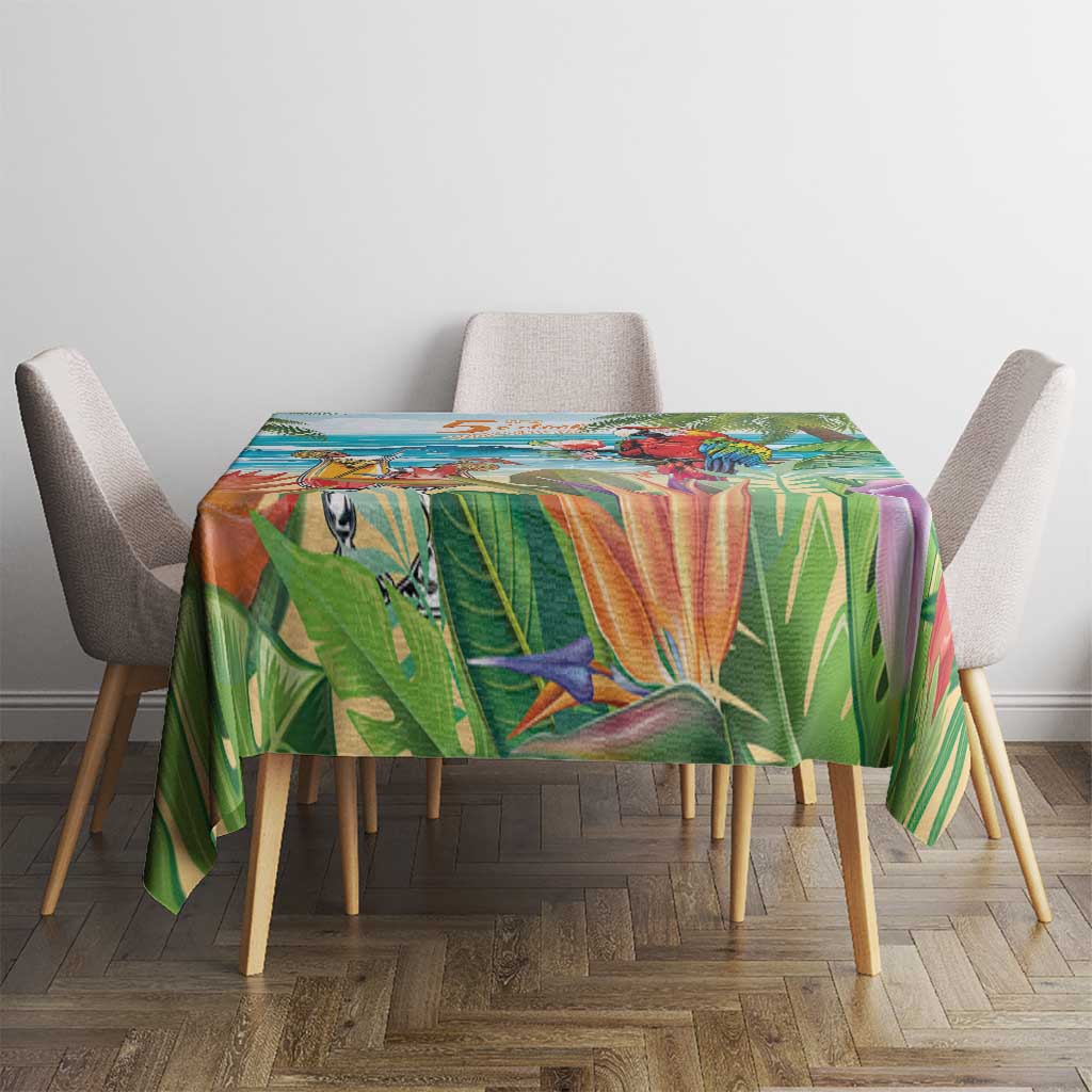 Colorful tropical tablecloth with parrot and palm foliage artwork over a dining table
