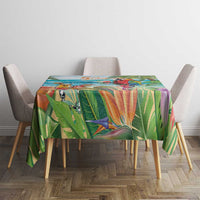 Colorful tropical tablecloth with parrot and palm foliage artwork over a dining table