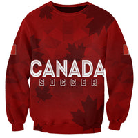 Women’s red soccer sweatshirt with Canada Soccer graphic and maple leaf pattern