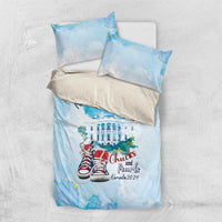 Blue bedding set with “I'm with her” and Chucks and Pearls sneakers on duvet