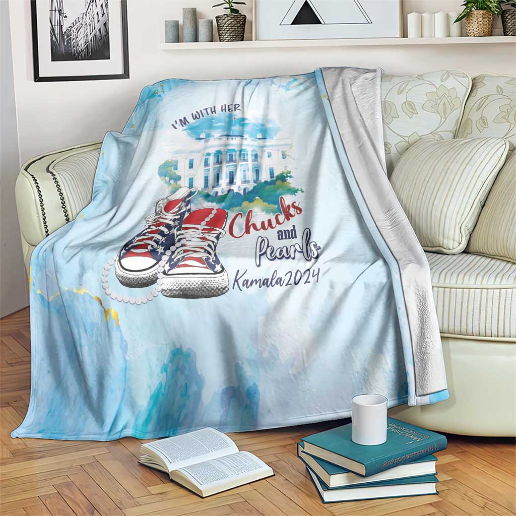 Light blue blanket draped over couch with 'I'm with her' text and red sneakers illustration