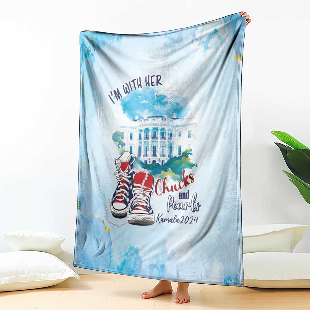 Light blue blanket with 'I'm with her' text, building graphic, and red sneakers